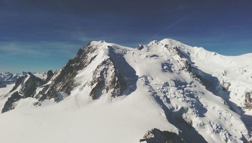 Scenic view of snow covered mountains against sky