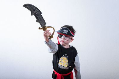 Low angle view of young woman standing against wall