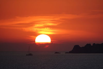 Scenic view of sea against romantic sky at sunset