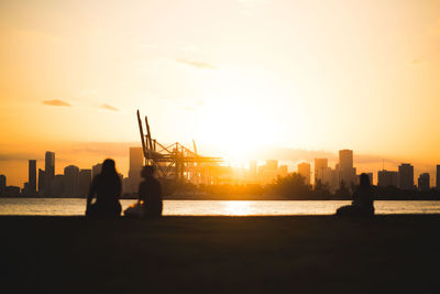 Silhouette of buildings against sky during sunset