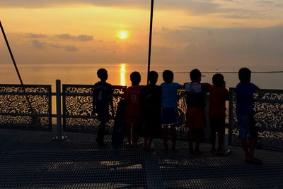 Silhouette of people at sunset