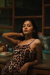 Portrait of young woman sitting at home