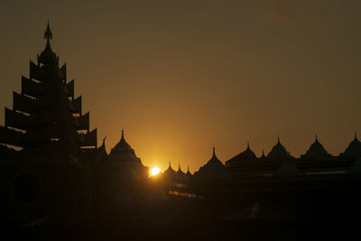 Silhouette of building against sky during sunset