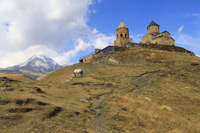 Low angle view of trinity church in gergeti, georgia, asia 