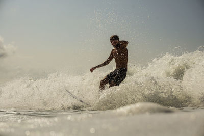 Man splashing water in sea