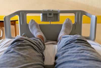 Concept health and medicine, selfie of feet with white socks of a patient sitting in a hospital bed