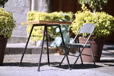 Empty chairs and table in park