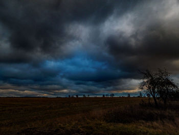 Scenic view of dramatic sky over field