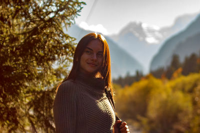 Nice girl traveler in the background of the mountains