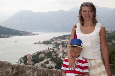 Portrait of smiling woman standing on mountain