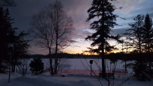 Scenic view of lake against sky during winter