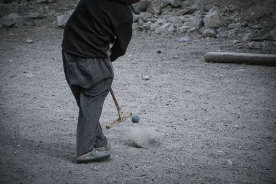 Low section of man playing with ball