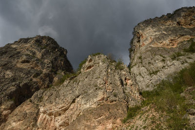 Low angle view of rock formations against sky