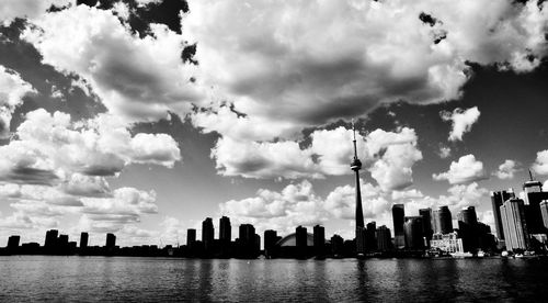 Panoramic view of buildings against cloudy sky