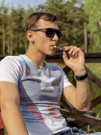 Young man smoking cigarette