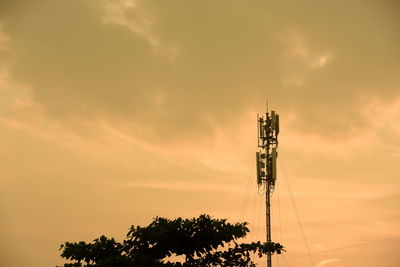 Low angle view of communications tower against sky