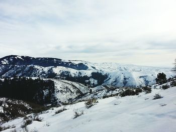 Scenic view of mountains against cloudy sky