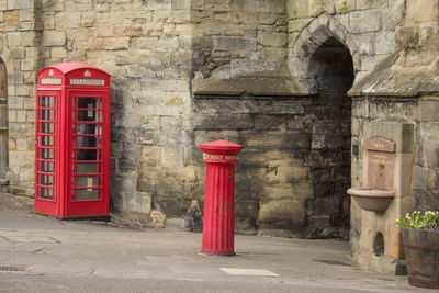 Telephone booth by wall