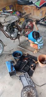 High angle view of man working on metal