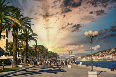 Group of people on street at sunset
