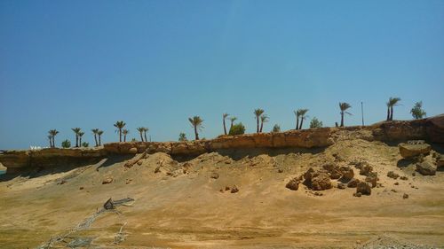 View of desert against clear blue sky