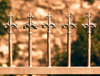 Close-up of metal fence against railing