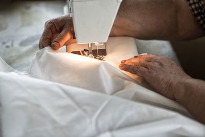 Midsection of man working on bed