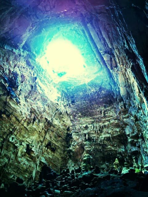 LOW ANGLE VIEW OF ILLUMINATED CAVE
