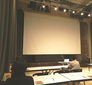 Rear view of man sitting in kitchen