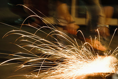 Manual worker cutting metal with equipment at workshop