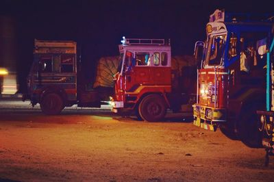 People working on motorcycle at night