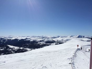 Scenic view of snowcapped mountains against clear sky