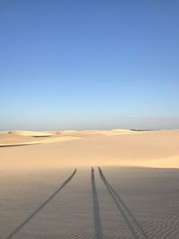 Scenic view of desert against clear blue sky