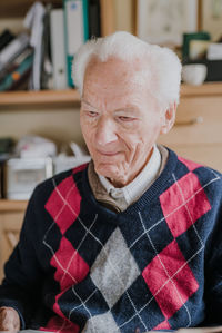 Portrait of smiling man sitting at home