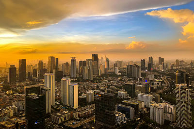 High angle view of modern buildings against sky during sunset