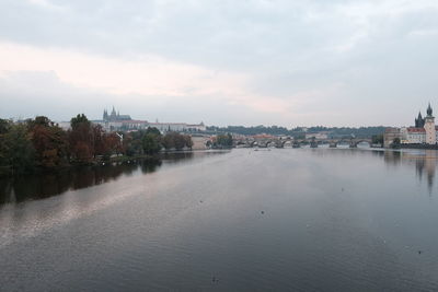 River by townscape against sky