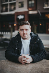 Portrait of young man sitting outdoors