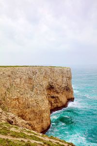 Scenic view of rocks in sea against sky