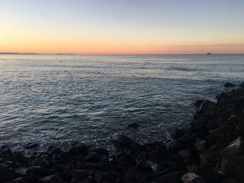 Scenic view of sea against clear sky during sunset