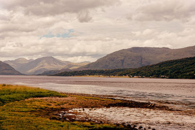 Scenic view of lake and mountains against sky