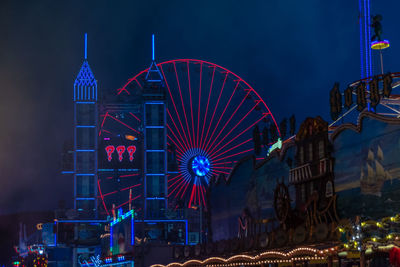 Illuminated ferris wheel at night