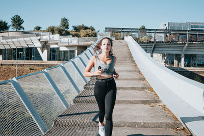 Female athlete running on steps