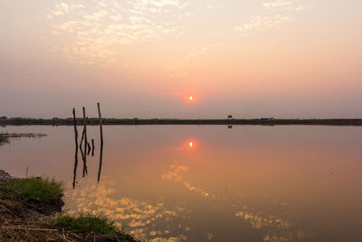 Scenic view of lake against sky during sunset