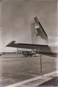 Airplane on runway against sky