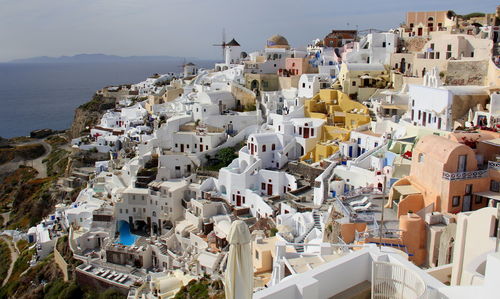 High angle view of town by sea against sky