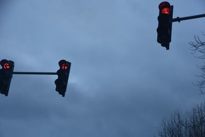 Low angle view of road signal against sky