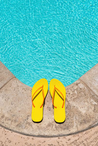 Low section of woman standing on poolside