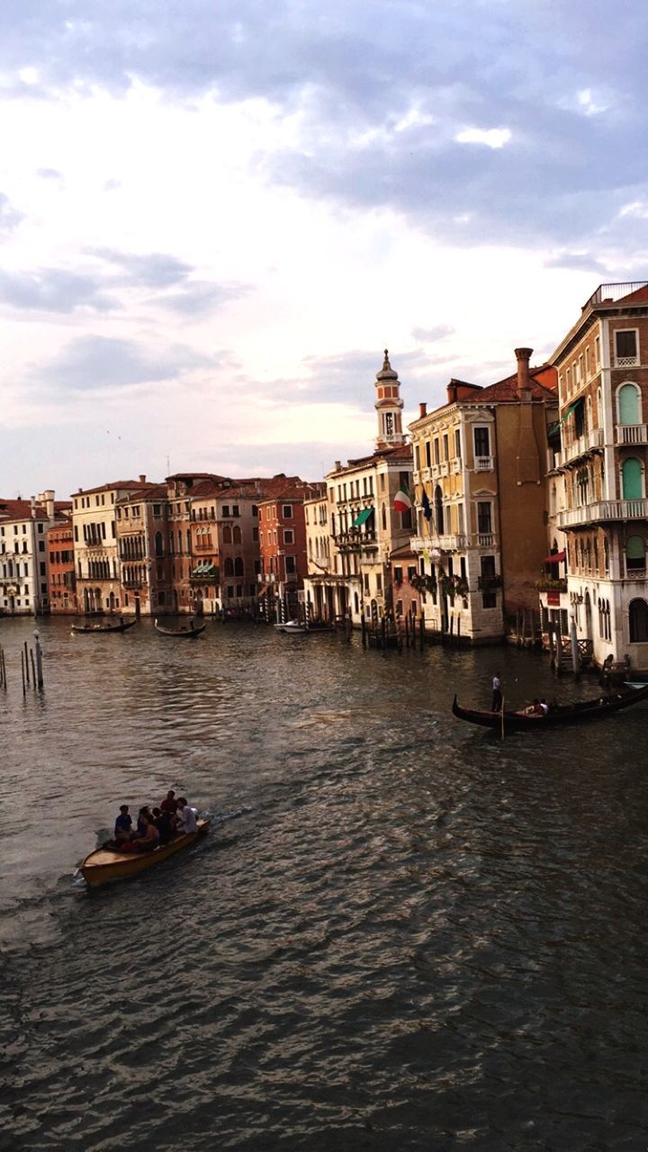 building exterior, architecture, built structure, water, waterfront, nautical vessel, sky, transportation, boat, mode of transport, city, cloud - sky, canal, residential building, residential structure, men, river, cloud, city life