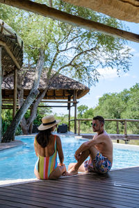 Side view of man sitting on hammock