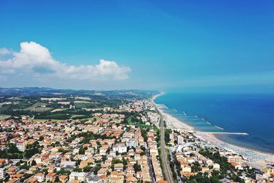 High angle view of townscape by sea against sky